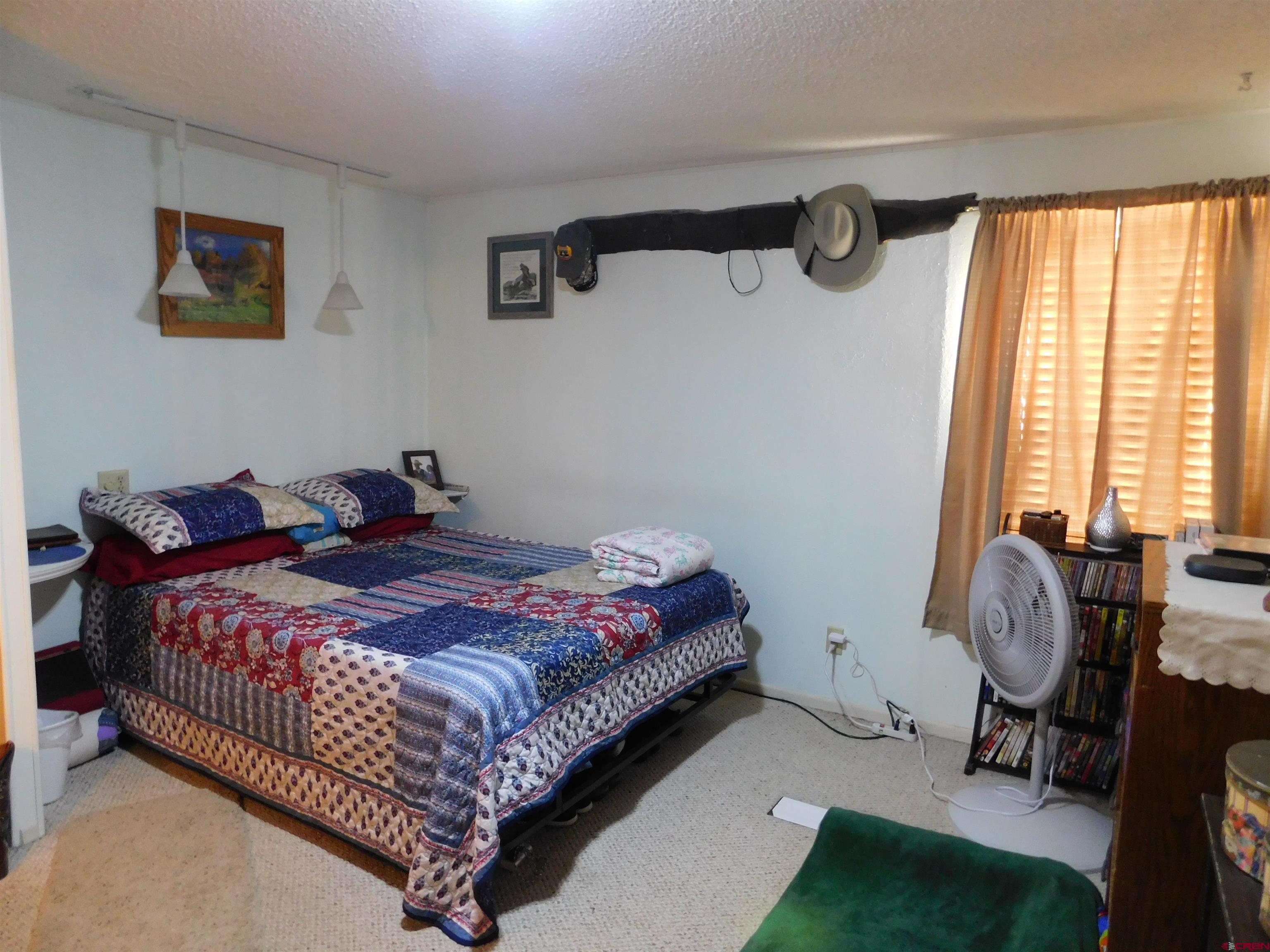 23300 Rd X Lewis, CO 81327 - Photo 17 of 44 a bedroom with bed and a window