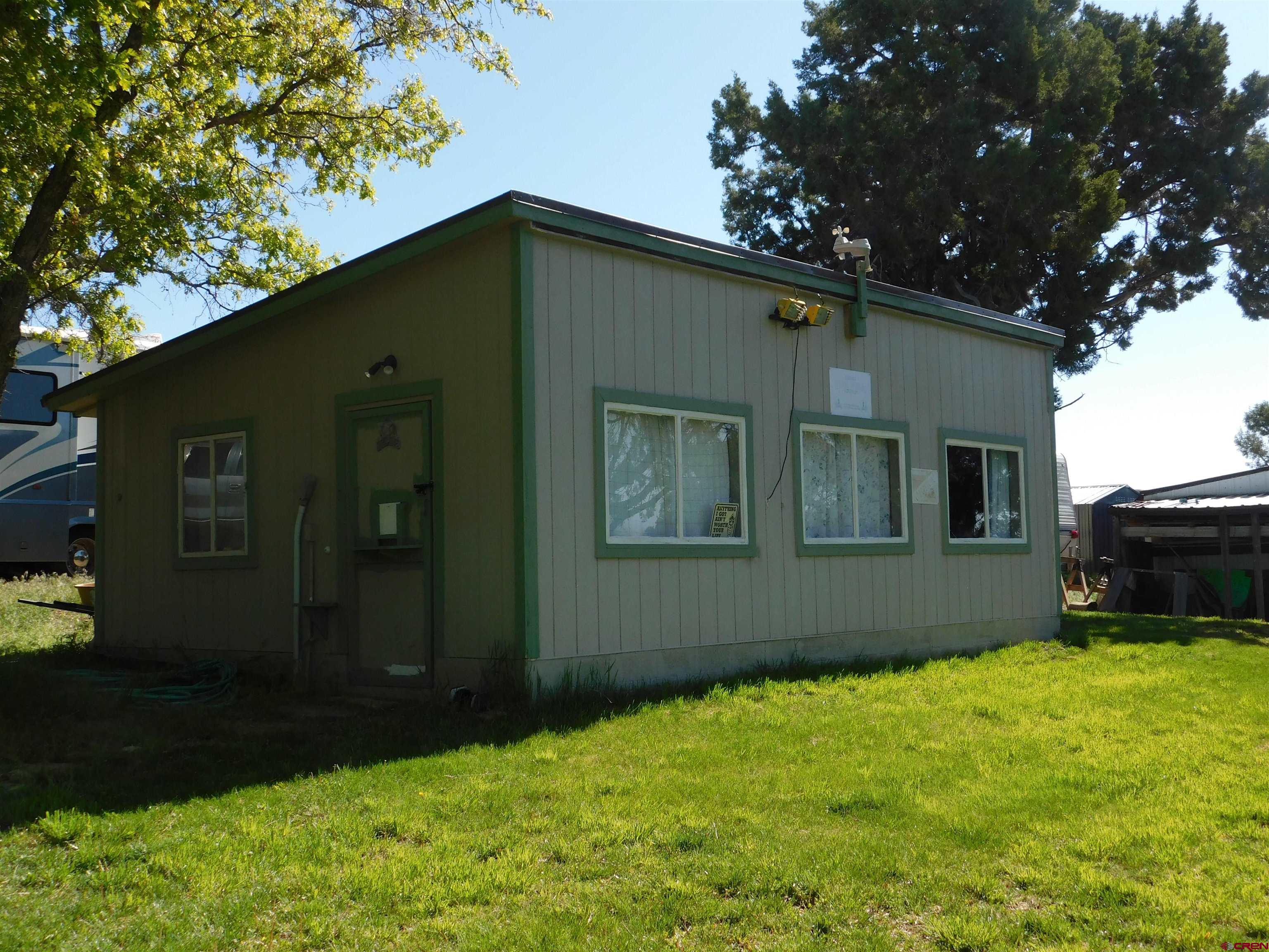 23300 Rd X Lewis, CO 81327 - Photo 22 of 44 a backyard of a house with lots of green space