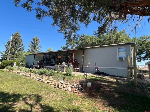 a view of a swimming pool with a patio and garden