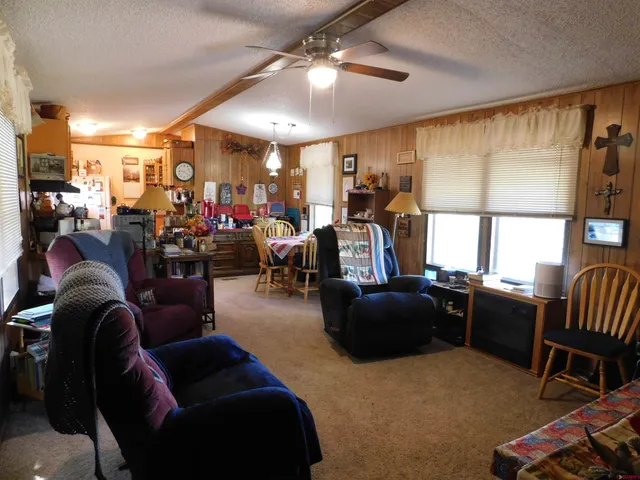 a living room with lots of furniture and a large window
