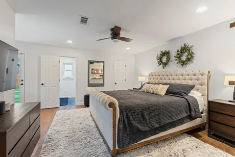 a bedroom with a bed and a chandelier