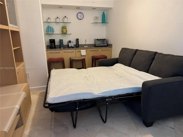 a large white kitchen with a sink and cabinets