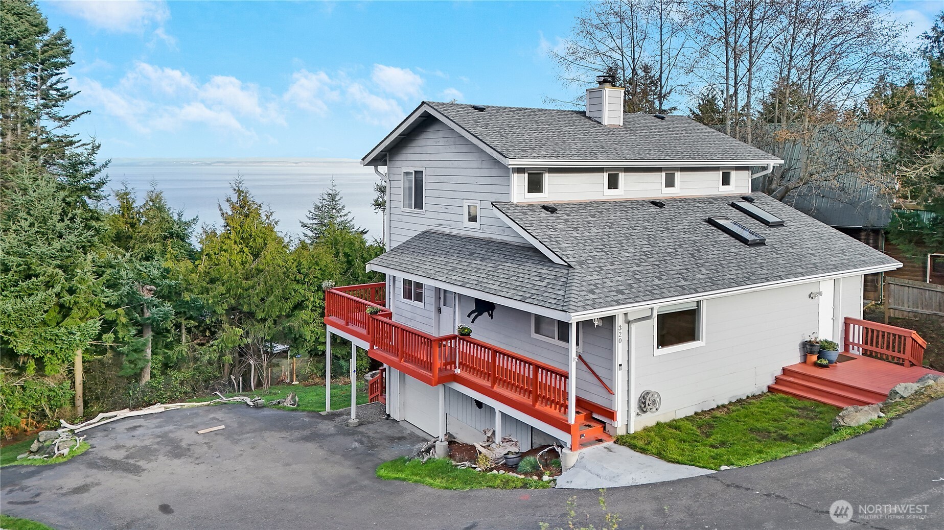 a aerial view of a house with a yard and potted plants