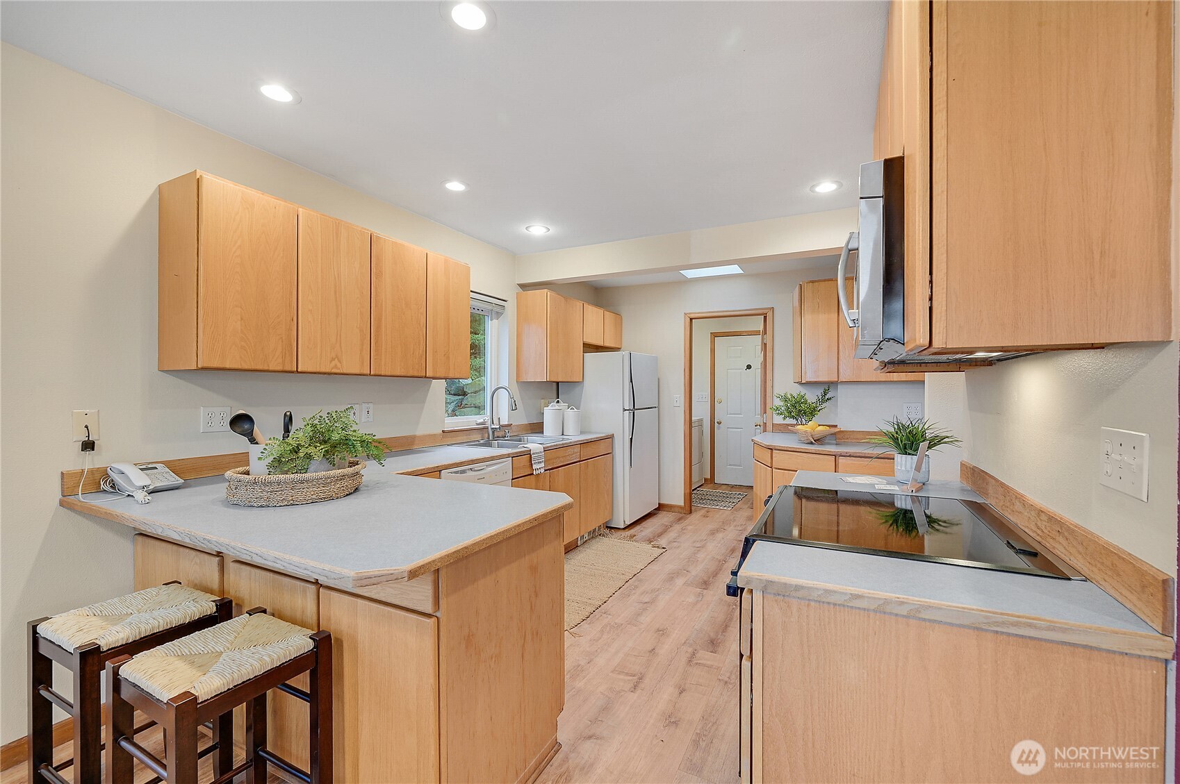 320 North Street Sequim, WA 98382 - Photo 15 of 40 a kitchen with a sink white cabinets and stainless steel appliances
