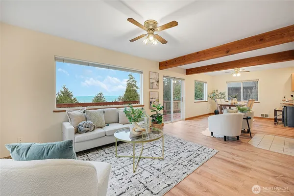 a living room with furniture and a chandelier