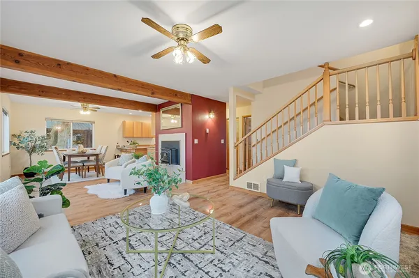 a living room with furniture and a potted plant