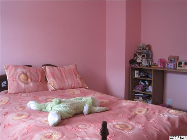 5927 Brightstar Valley Road Mint Hill, NC 28227 - Photo 11 of 14 a bedroom with a bed and a book shelf