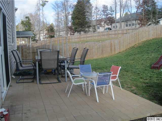 5927 Brightstar Valley Road Mint Hill, NC 28227 - Photo 4 of 14 a view of a patio with table and chairs and couches with wooden fence