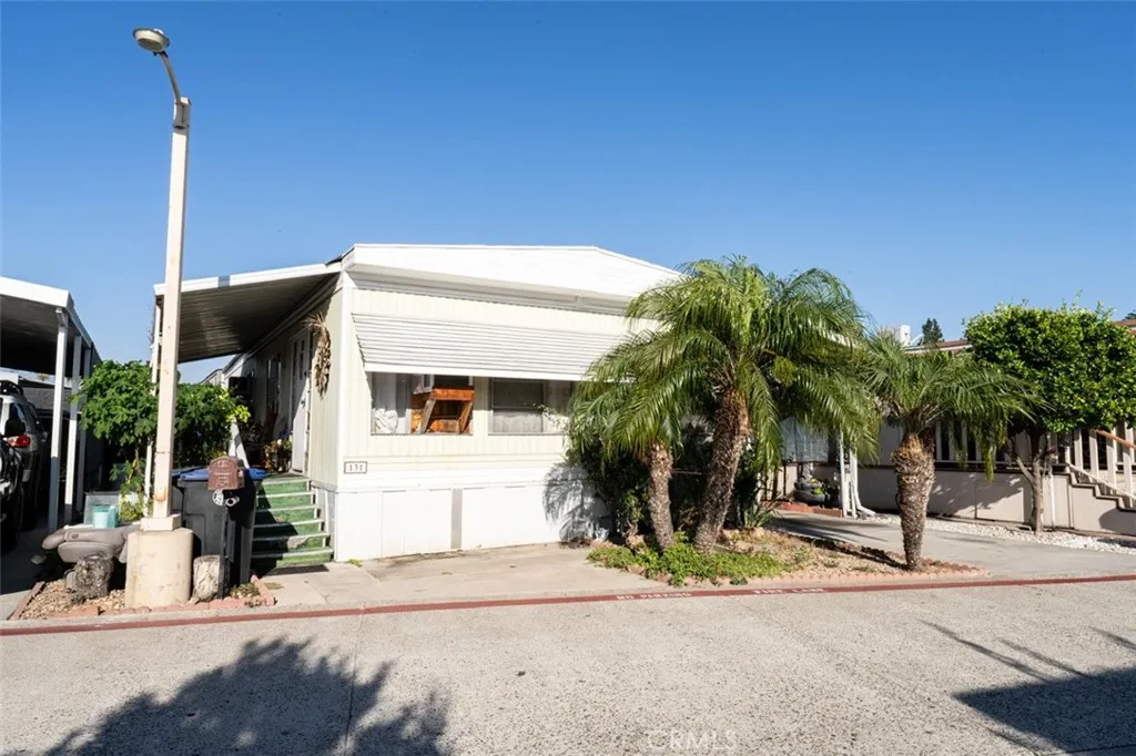 131 South Colombo Tustin, CA 92780 - Photo 1 of 19 a view of a house with a yard and palm trees