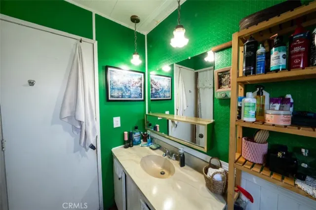 a bathroom with a sink mirror and window
