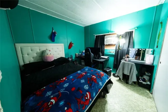 a bedroom with a bed and a television