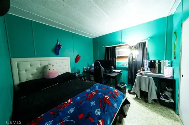 a bedroom with a bed and a flat tv screen