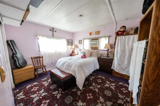 a bed room with a bed furniture and a window