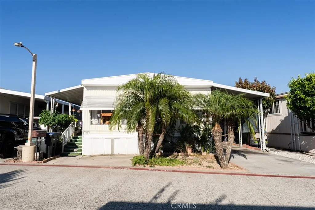 131 South Colombo Tustin, CA 92780 - Photo 2 of 19 a man walking down a street next to a building