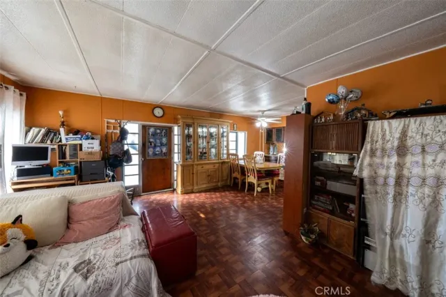 a living room with furniture a flat screen tv and a floor to ceiling window