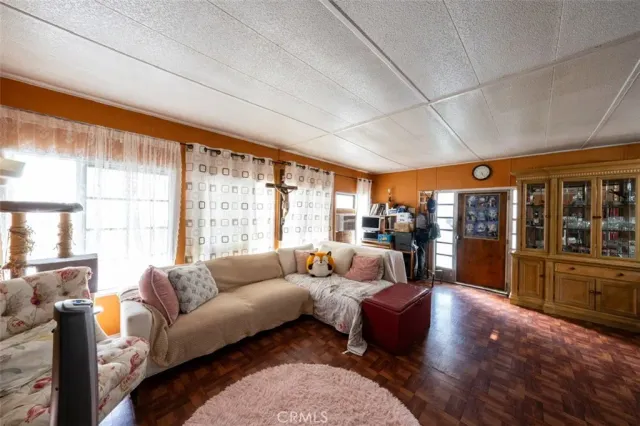 a living room with furniture and large windows