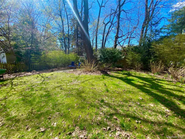 a backyard of a house with lots of green space and fountain