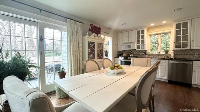 a dining room with wooden floor and furniture