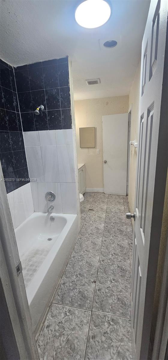 3932 Northwest 207 St Road Miami Gardens, FL 33055 - Photo 12 of 19 a bathroom with a sink a toilet a mirror and bathtub