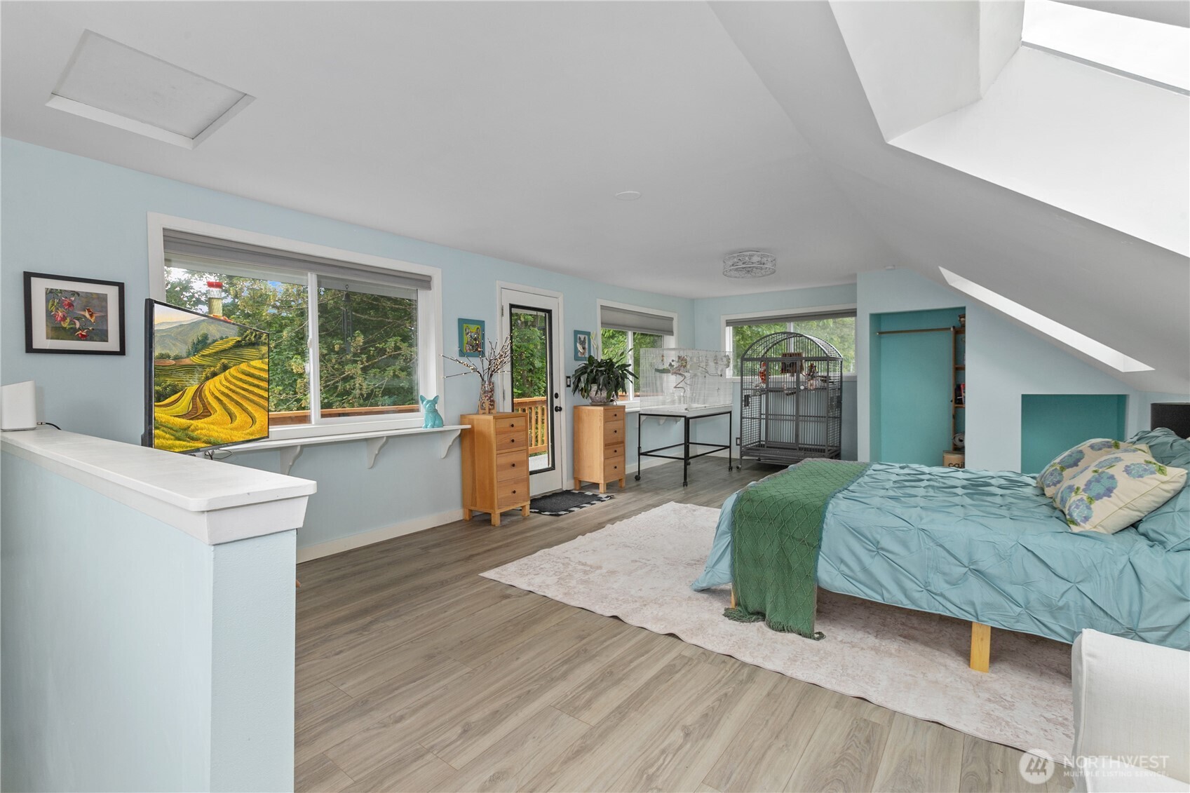 24522 Cromwell Road Monroe, WA 98272 - Photo 16 of 40 a spacious bedroom with a bed a table and large windows