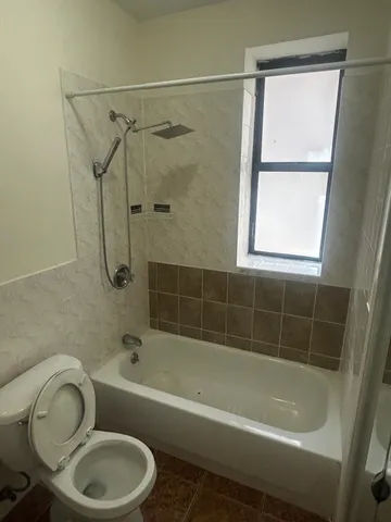 a bathroom with a sink a window and a shower