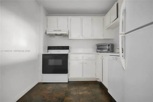 a view of microwave and cabinets