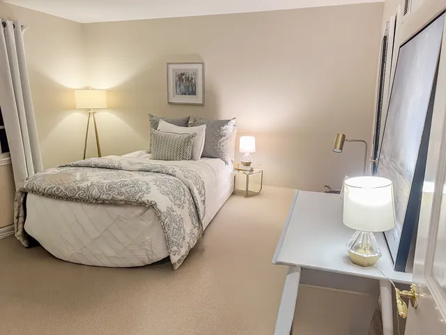 a bedroom with a bed and a lamp