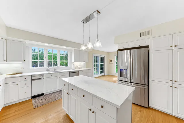 a kitchen with white cabinets and stainless steel appliances