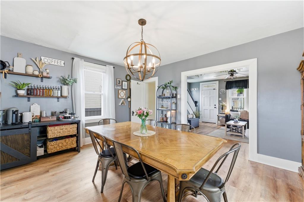 1438 4th Street Natrona Heights, PA 15065 - Photo 20 of 33 a view of a dining room with furniture a chandelier and wooden floor