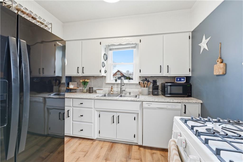 1438 4th Street Natrona Heights, PA 15065 - Photo 21 of 33 a kitchen with granite countertop a sink cabinets and stainless steel appliances