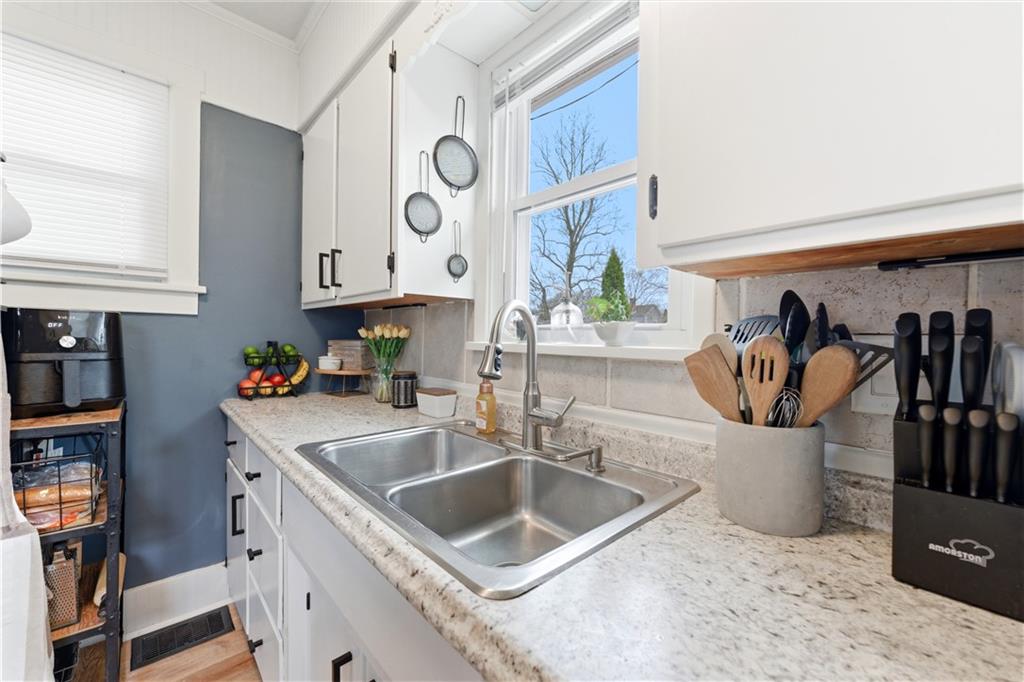 1438 4th Street Natrona Heights, PA 15065 - Photo 22 of 33 a kitchen with a sink and a refrigerator