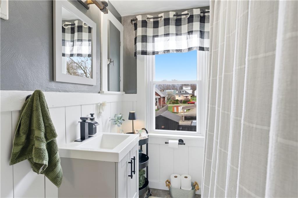 1438 4th Street Natrona Heights, PA 15065 - Photo 24 of 33 a bathroom with a sink and a mirror