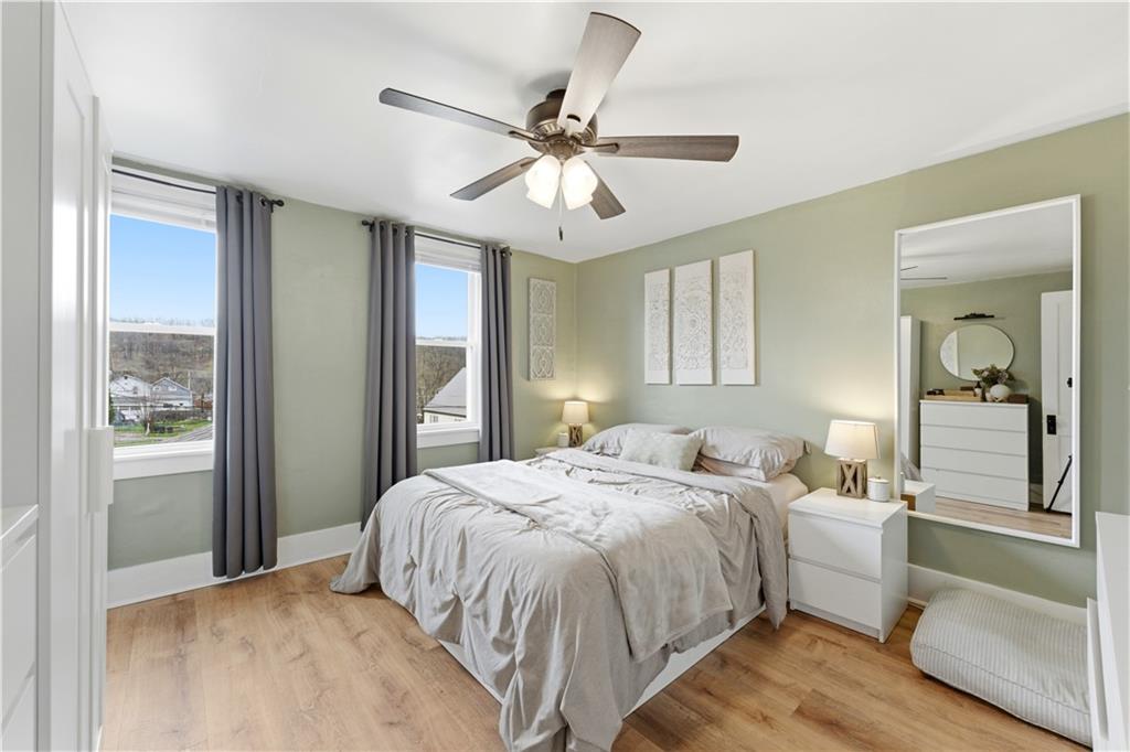 1438 4th Street Natrona Heights, PA 15065 - Photo 27 of 33 a bedroom with a large bed and a chandelier