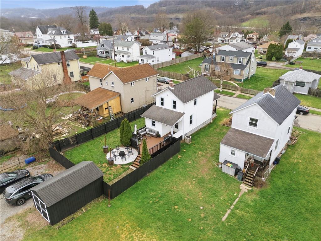 1438 4th Street Natrona Heights, PA 15065 - Photo 4 of 33 an aerial view of a house with garden space and mountain view in back