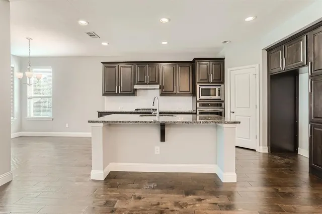 a kitchen with a stove and a sink