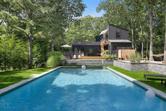 a view of a house with swimming pool and sitting area
