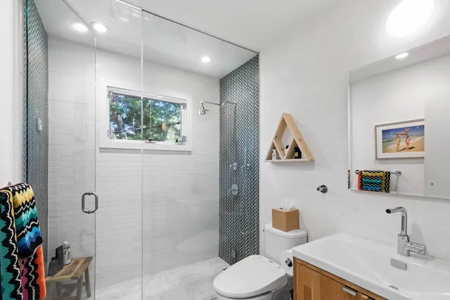 a bathroom with a toilet sink and shower