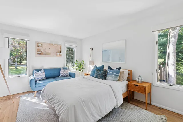 a bedroom with bed and a window