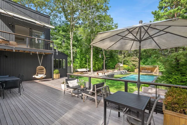 a view of a patio with a table chairs and a fire pit