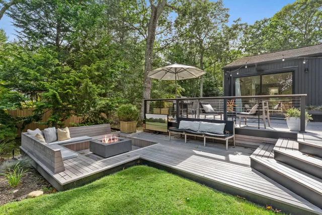 a view of a backyard with couches table and chairs