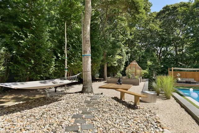 a view of a lounge chair in the patio next to a yard