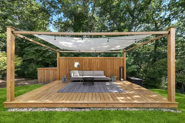 a view of a backyard with sitting area