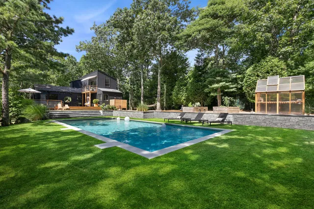 a view of a house with a backyard porch and sitting area