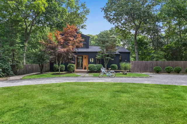 a view of a house with a yard and sitting area