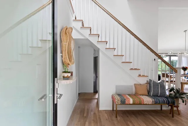 a view of entryway and hall with wooden floor