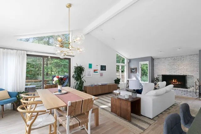 a living room with fireplace furniture and a chandelier