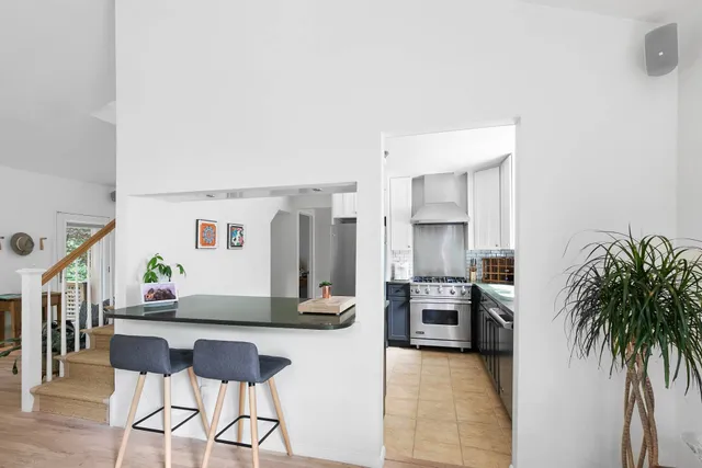 a living room with furniture and a kitchen area