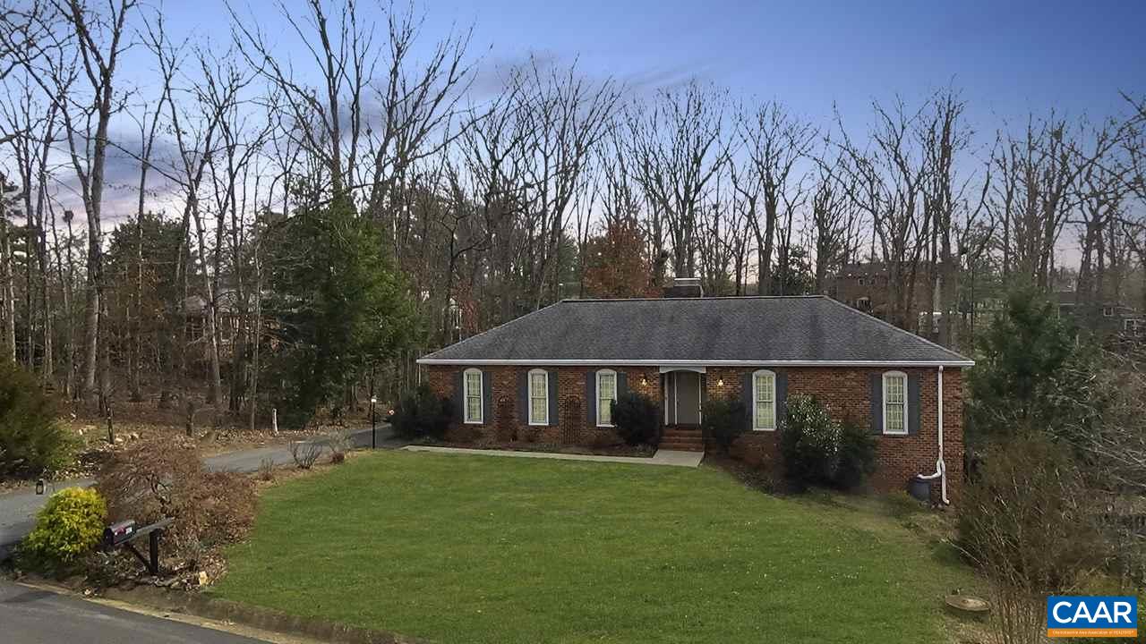 a front view of house with yard and trees