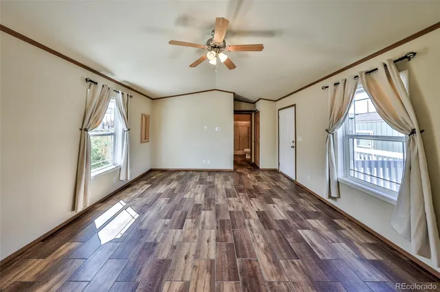 a view of an entryway with wooden floor and door