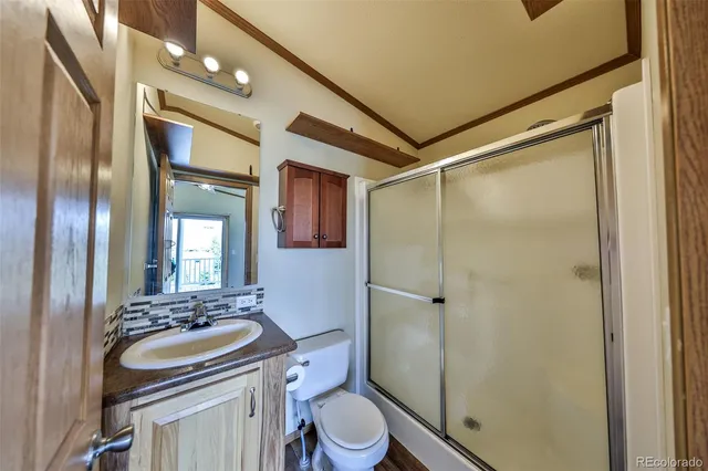 a bathroom with a sink toilet mirror and shower